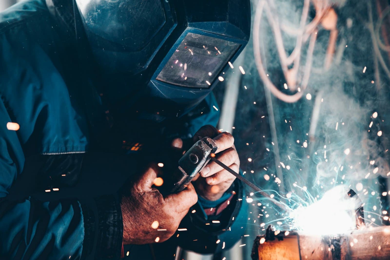 Industrial workers wearing hard hats and high-visibility clothing